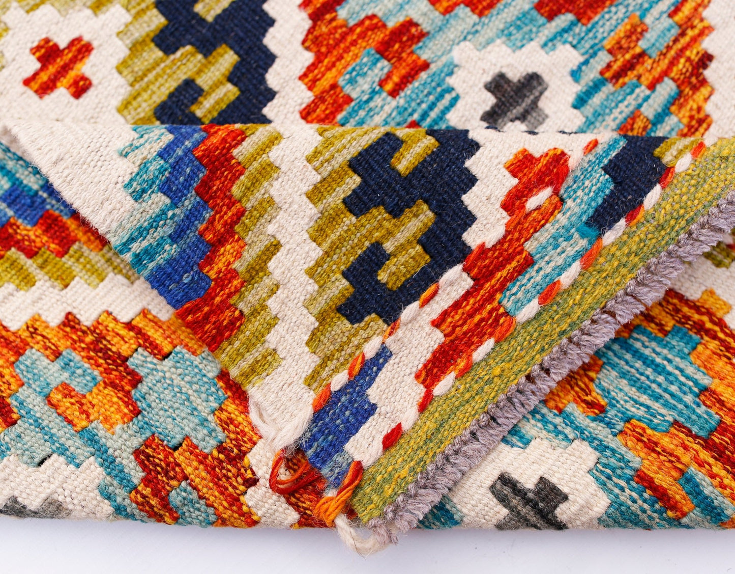 A handmade Afghan Maimana kilim runner featuring a vibrant geometric pattern in wool.