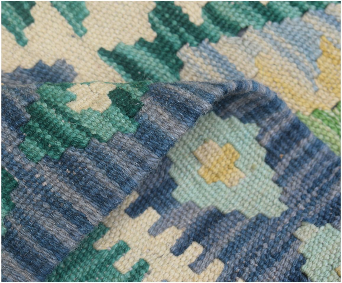 A close-up of a handmade Afghan Maimana kilim runner featuring geometric patterns in wool.