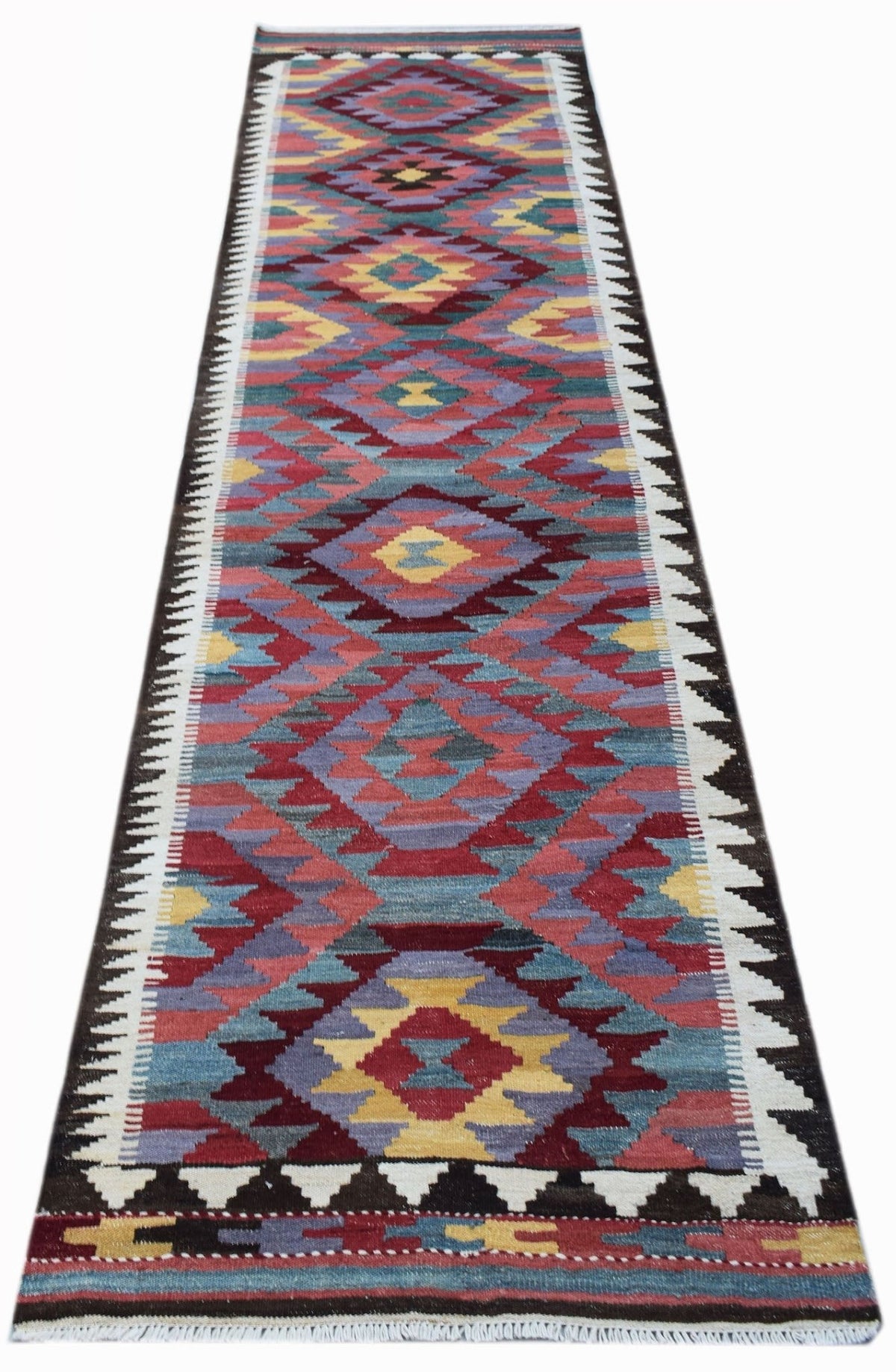 Handwoven Afghan Maimana kilim runner featuring repeating geometric patterns in red, blue, and yellow Ghazni wool.