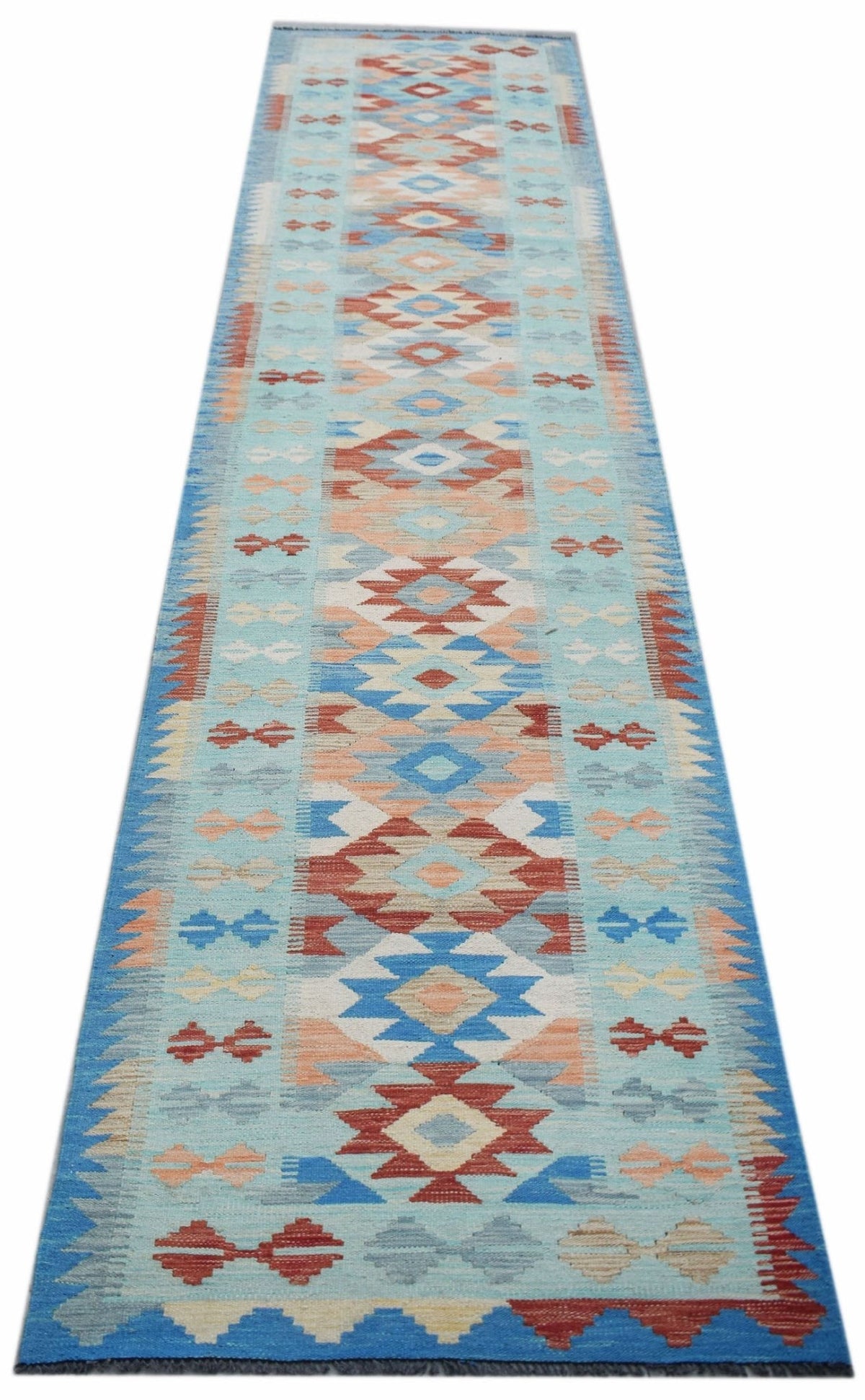 Handwoven Afghan Maimana wool runner featuring a geometric pattern in blue, red, and cream tones.