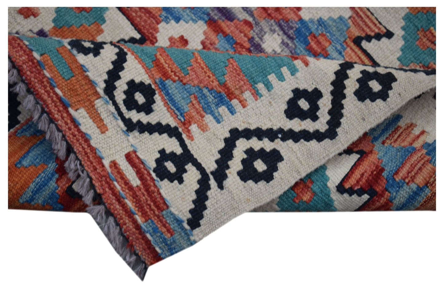 A handmade Afghan Maimana wool kilim runner featuring a geometric pattern in blue and orange.
