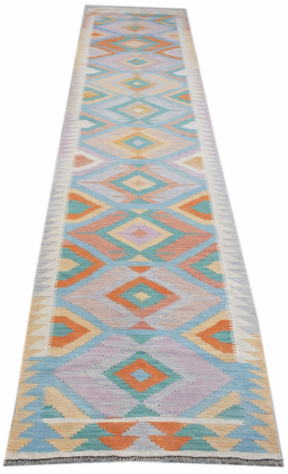 A handmade Afghan Maimana wool runner rug featuring a colorful geometric diamond pattern.