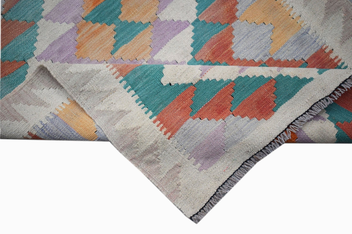A handmade Afghan Maimana kilim runner featuring a geometric pattern in vibrant multicolored wool.