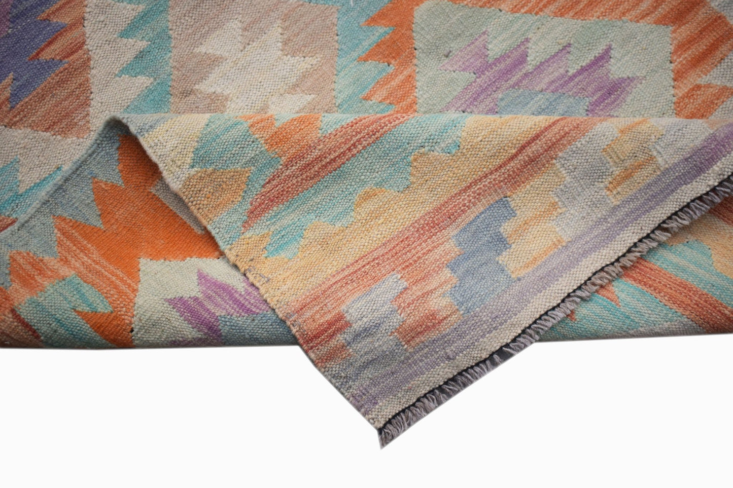 A handmade Afghan Maimana kilim runner featuring a geometric pattern in orange, blue, and purple.