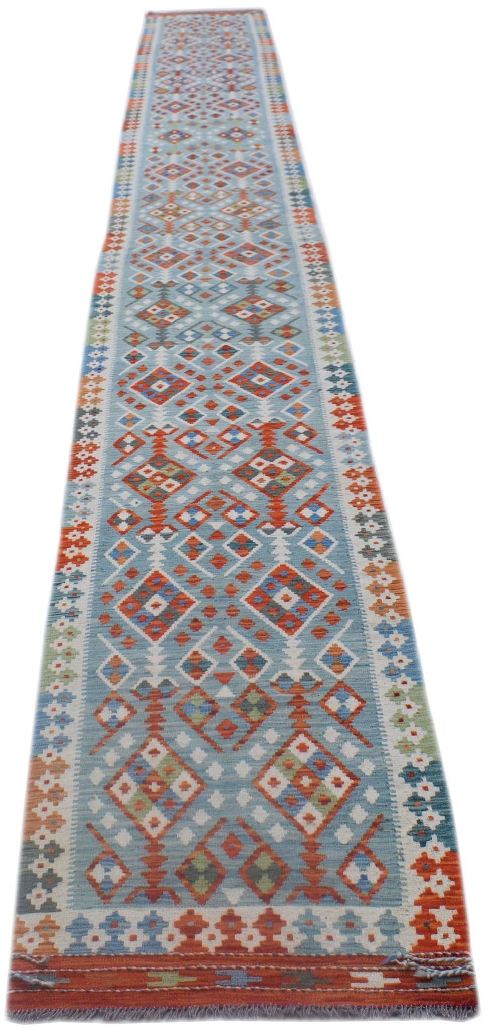 Handwoven Afghan Maimana wool runner rug featuring a light blue background with geometric patterns.