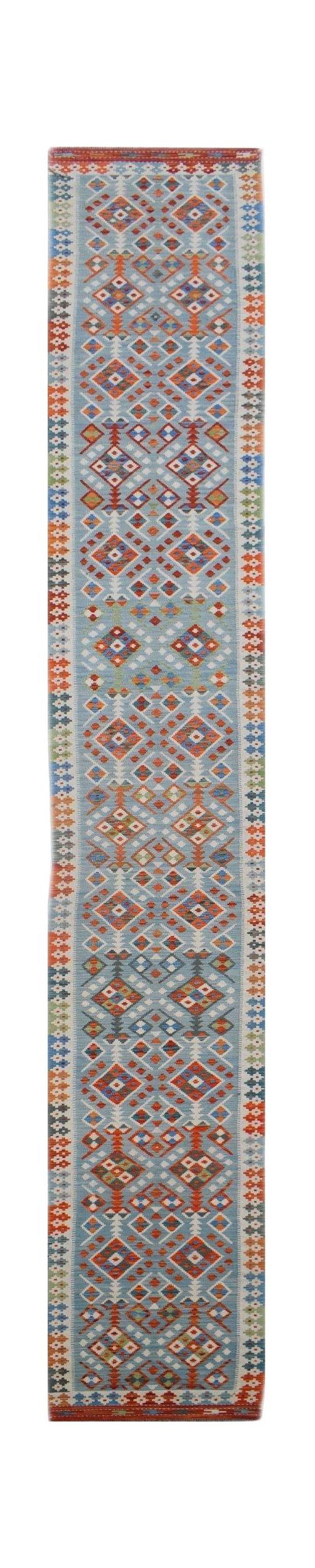 Handwoven Afghan Maimana wool runner rug featuring a light blue field with geometric patterns.