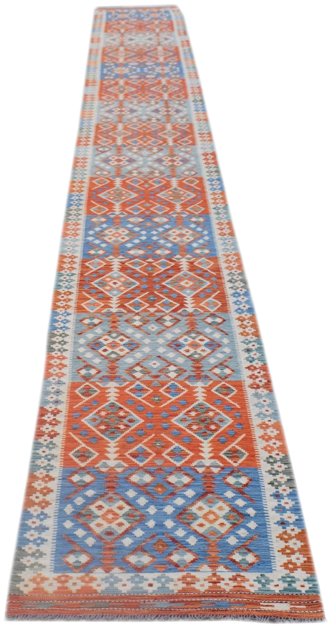 A long, handmade Afghan Maimana wool runner featuring a vibrant geometric pattern in blue and orange.