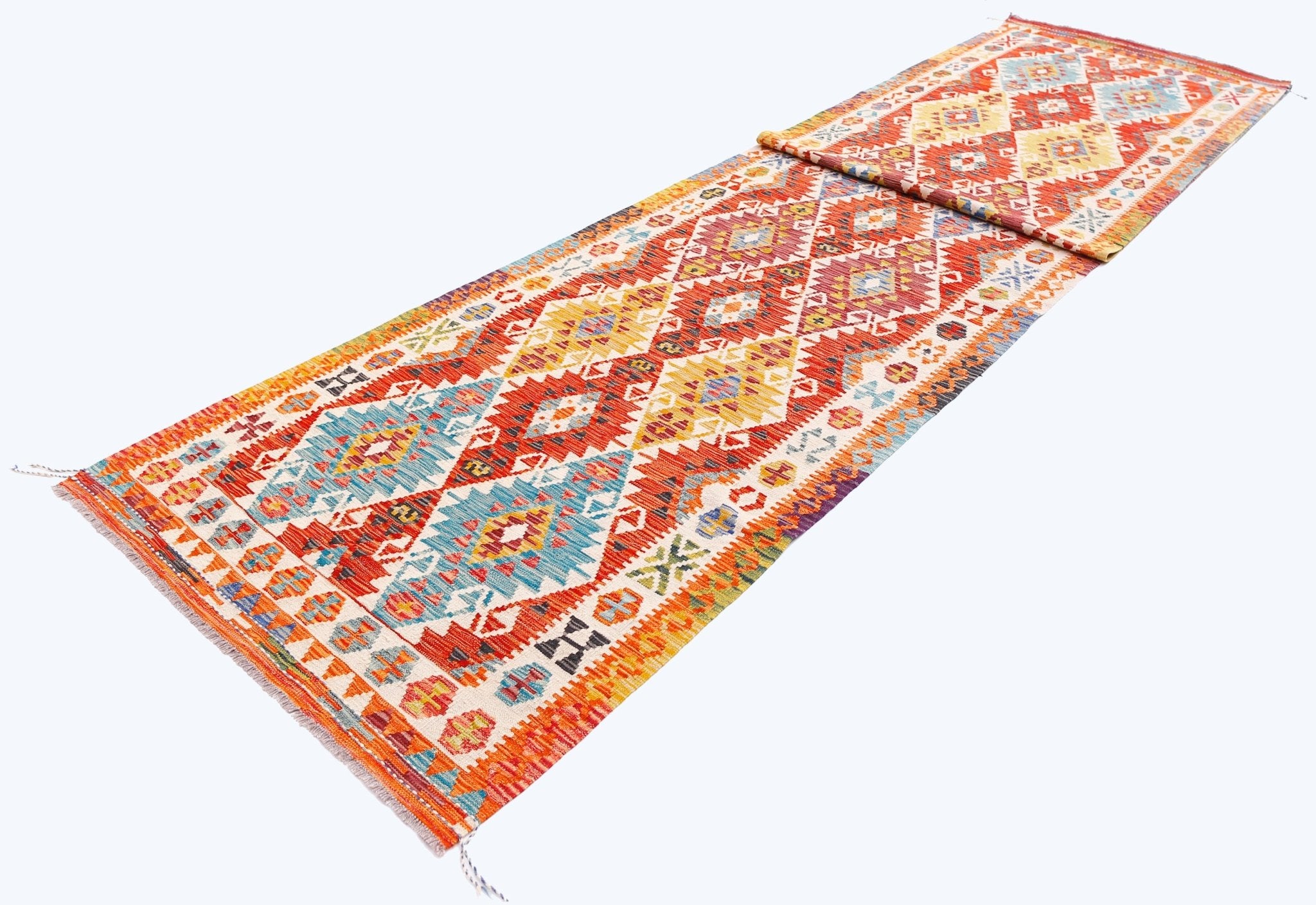 Handwoven Afghan Maimana wool runner rug featuring a vibrant geometric pattern in multi-colored hues.