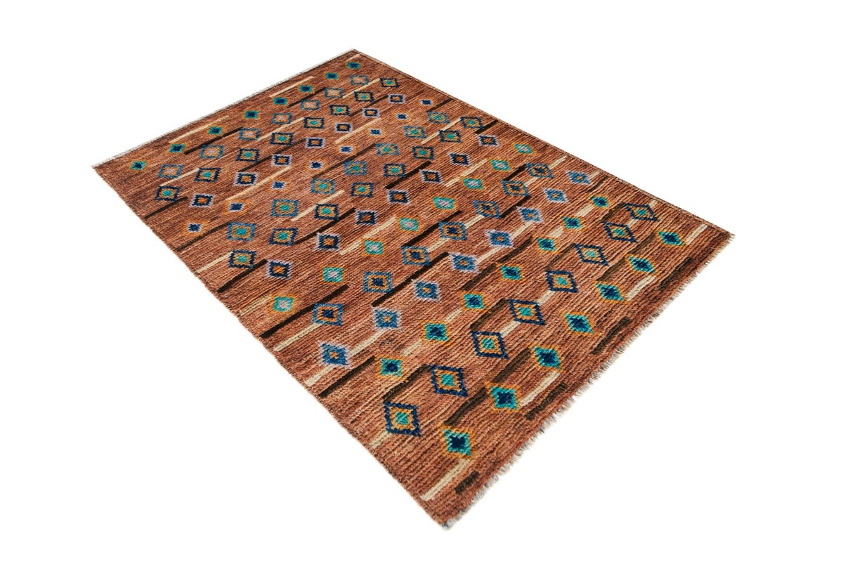Hand-knotted Afghan Pashm wool rug with a shaggy texture, featuring a geometric pattern in rust, blue, and cream tones.
