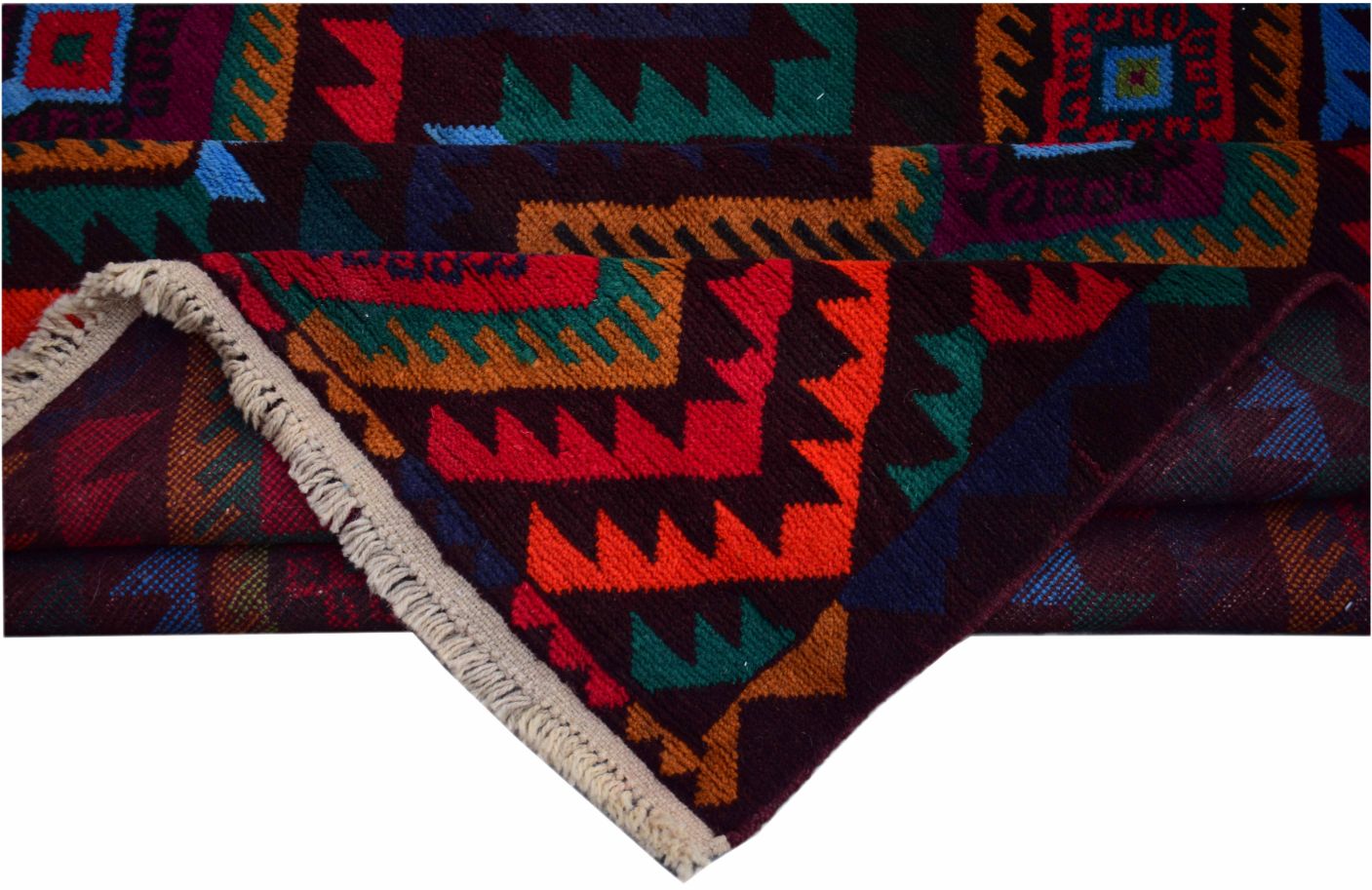 A handmade Afghan wool rug featuring a vibrant geometric tribal pattern in red, teal, and gold.