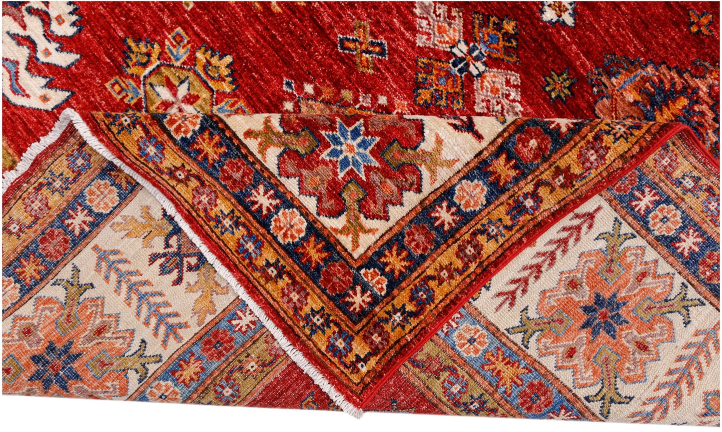 A handmade Afghan Super Kazakh rug featuring traditional geometric motifs in red, blue, and cream.