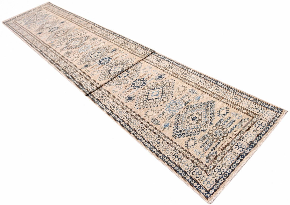 Afghan Super Kazakh wool runner featuring intricate blue and beige geometric medallions on a cream field with fringed ends.