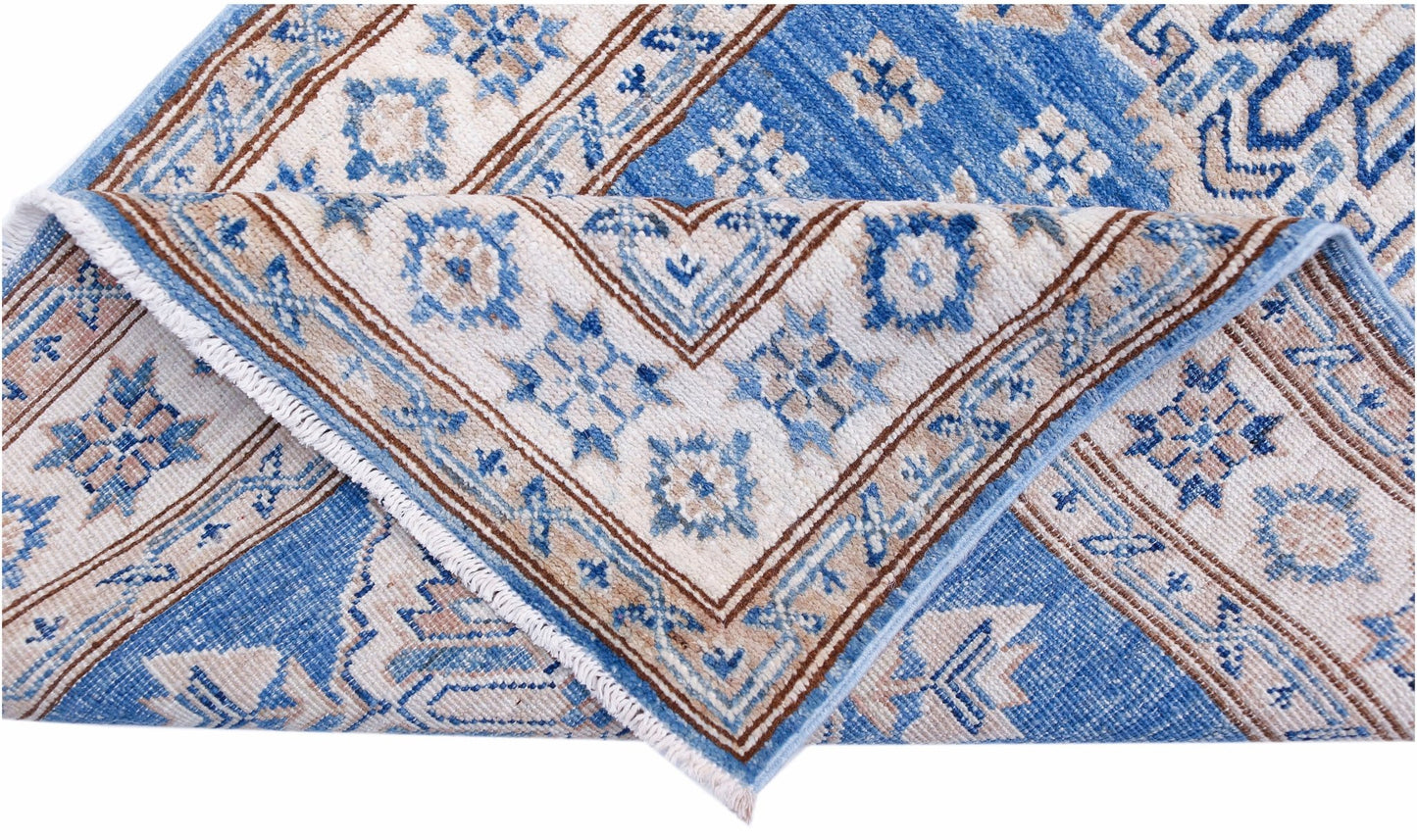 An Afghan Super Kazakh runner featuring traditional blue and beige geometric patterns.