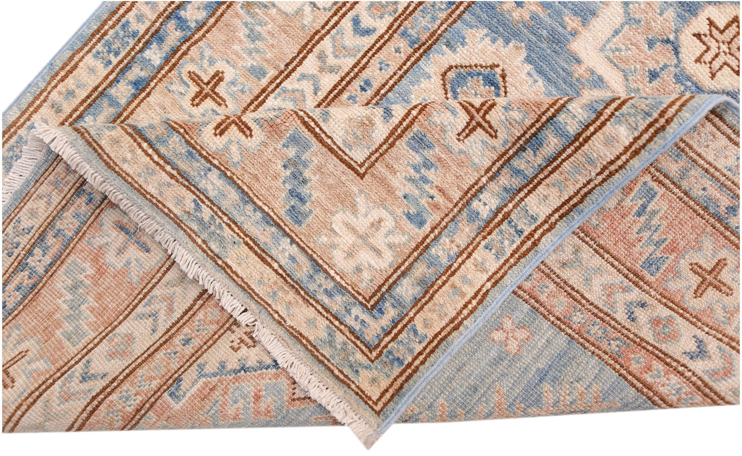 A folded Afghan Super Kazakh runner featuring traditional geometric motifs in blue and tan wool.