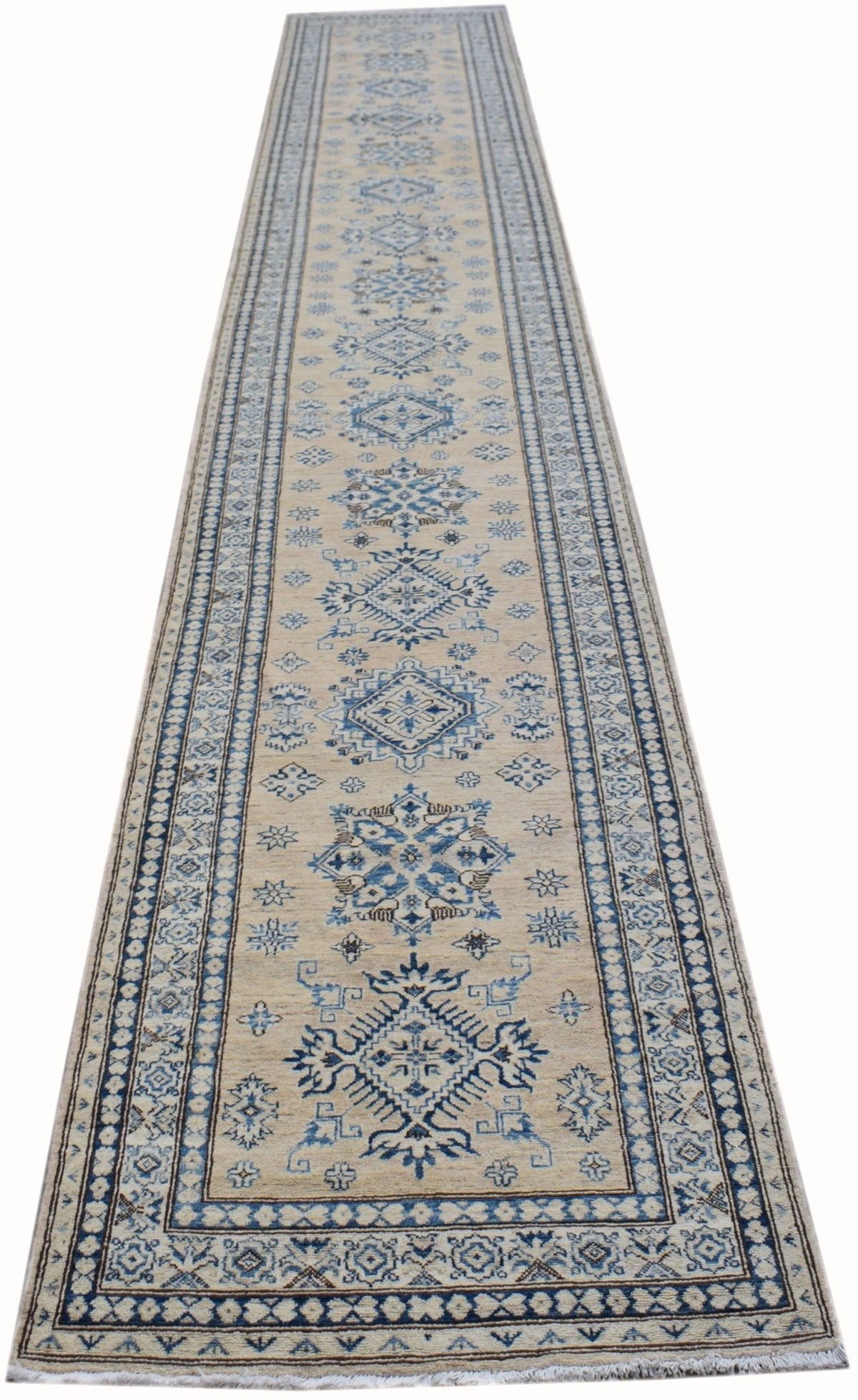 Hand-spun wool Afghan runner featuring blue Caucasian-style medallions on a cream field with intricate stepped borders.