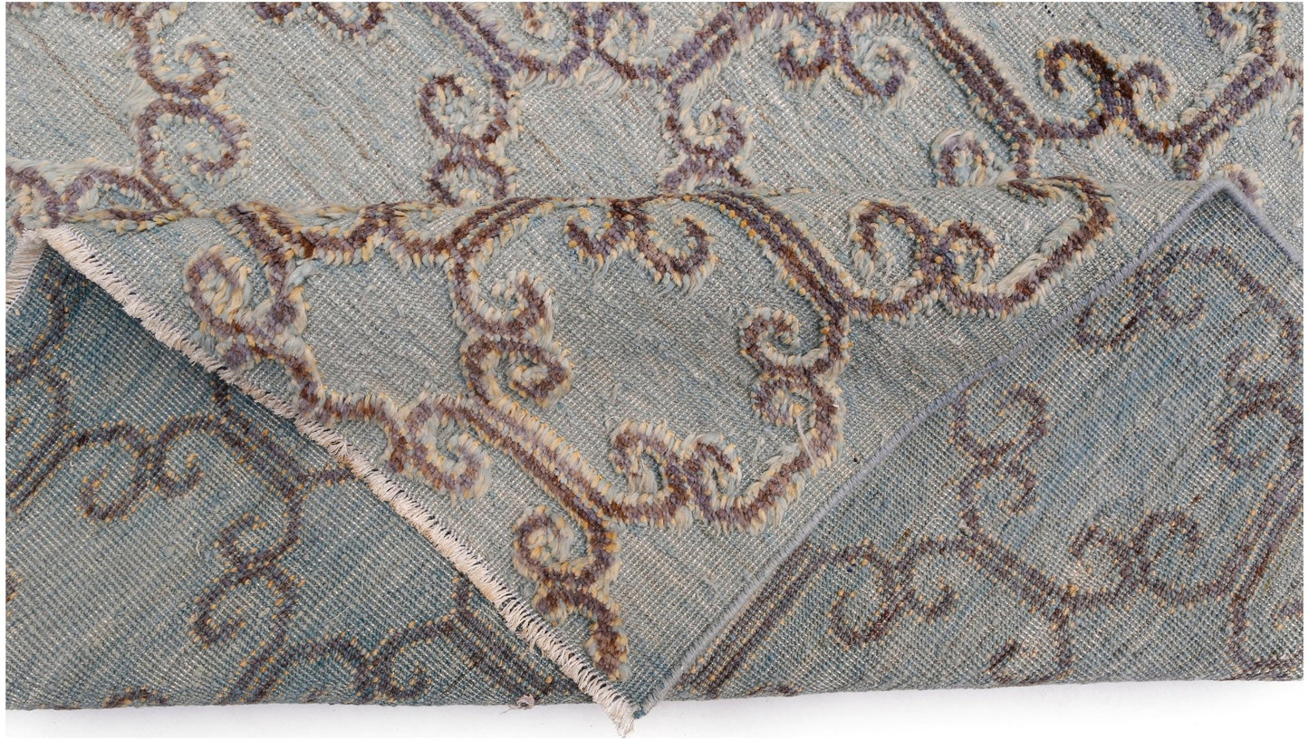 An Afghan Yekta rug featuring a blue field with raised, textured brown and cream scroll patterns.