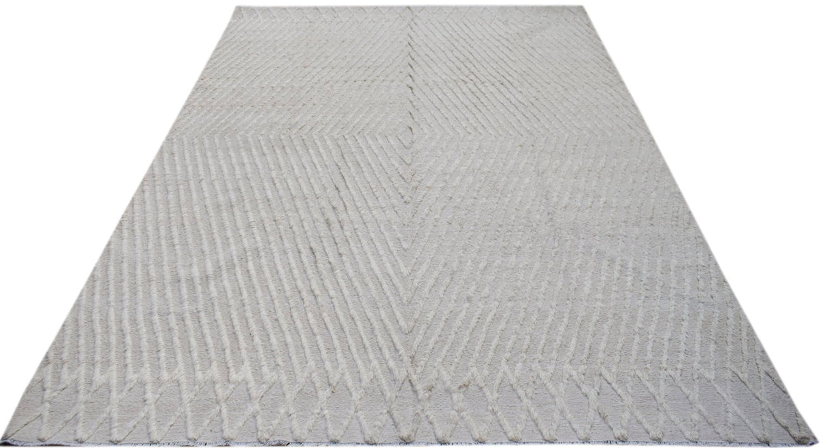 Cream-coloured Afghan Yekta rug with a geometric diamond pattern featuring raised hand-knotted pile on a flatweave base.