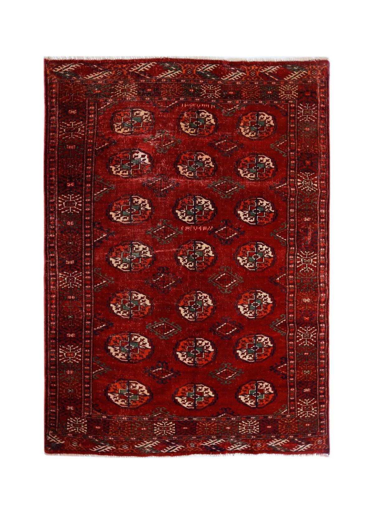 Antique Turkmen Tekke rug featuring rows of quartered red guls with intricate geometric details and a fringed edge.