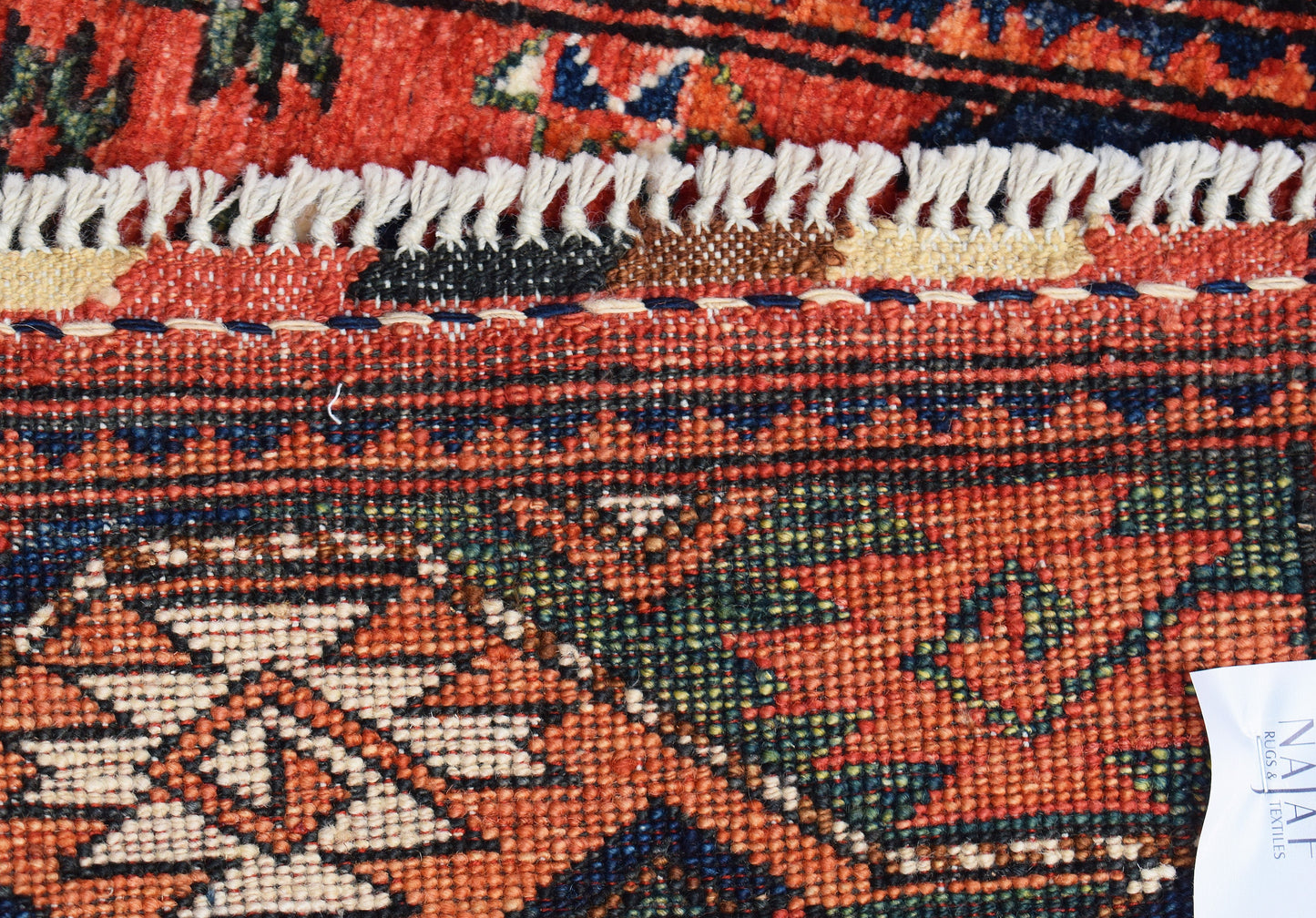 A close-up view of a handwoven Afghan Chobi runner featuring intricate patterns in wool.