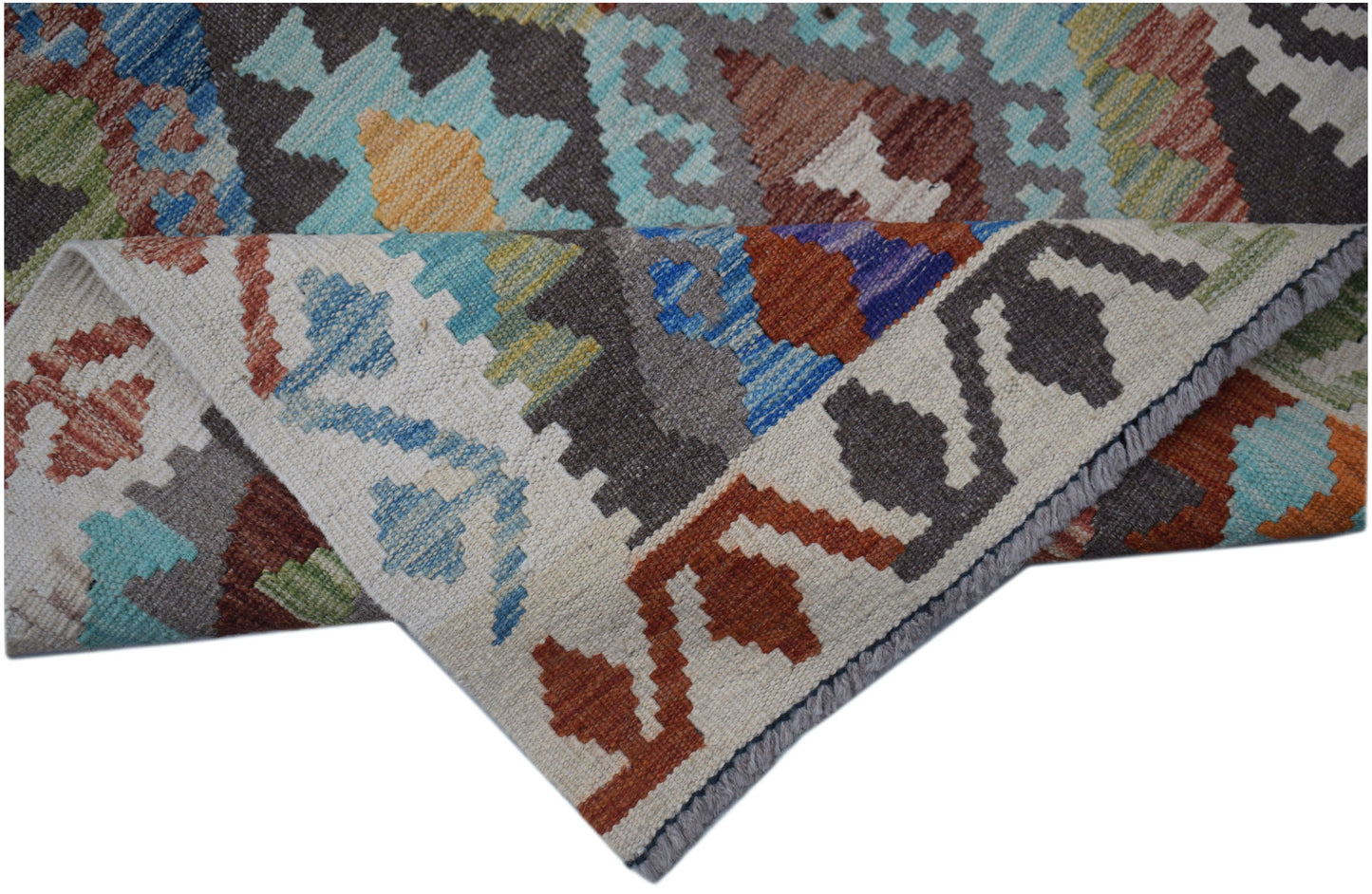 A handmade Afghan Maimana kilim runner featuring a geometric pattern in vibrant wool colors.
