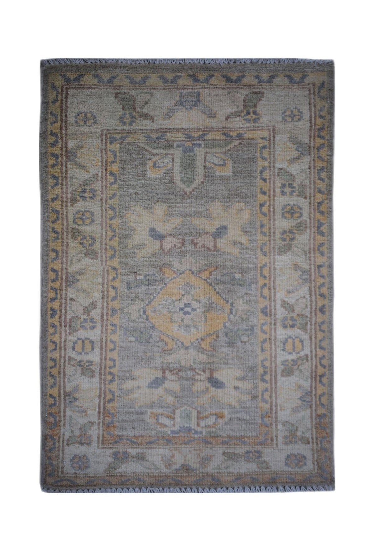 Mini Afghan Chobi rug in soft grey, blue, and yellow with intricate hand-knotted patterns and a short, fringed edge.