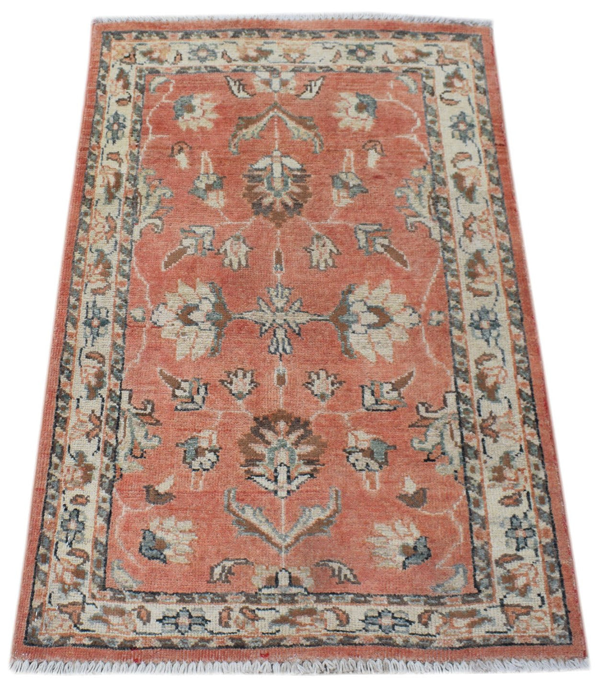 Hand-knotted Afghan Chobi rug in terracotta with intricate floral motifs, cream borders, and a short white fringe.