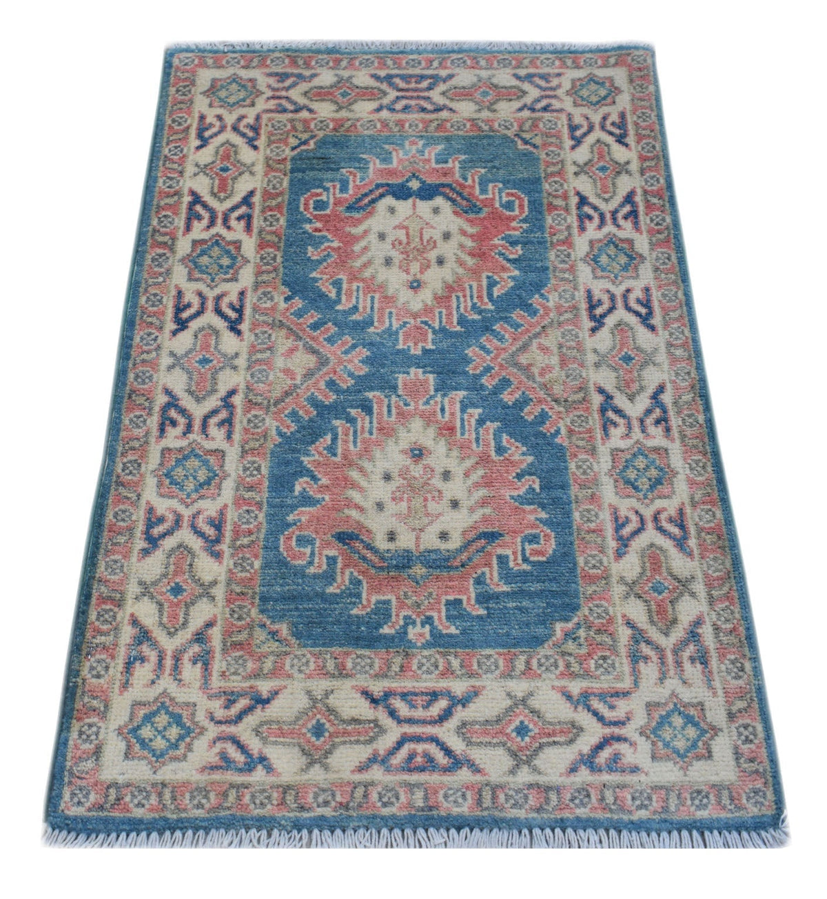 Hand-knotted mini Afghan Kazakh rug in blue and pink with geometric medallions, tribal symbols, and a short white fringe.