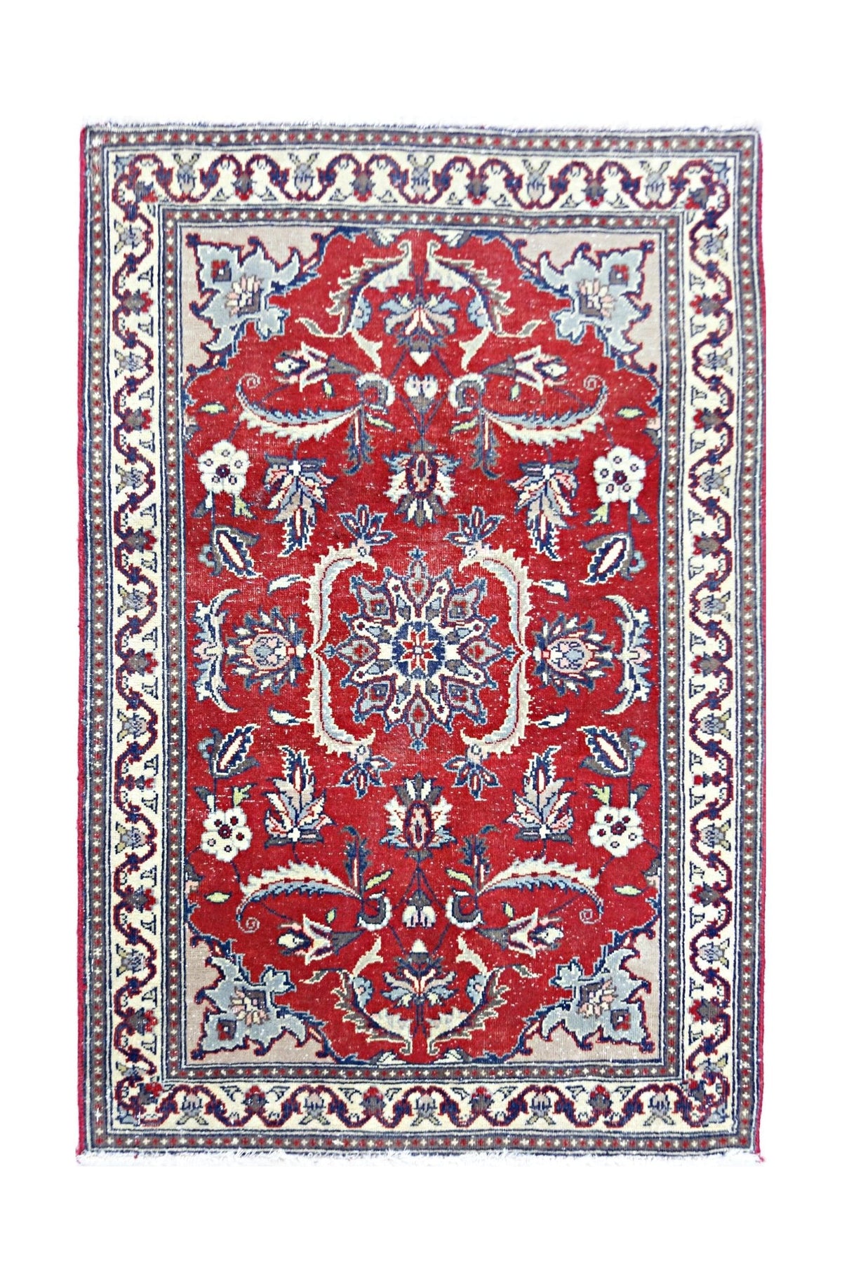 Vintage Pakistani mini rug with a central floral medallion, intricate red, blue, and cream patterns, and a detailed border.