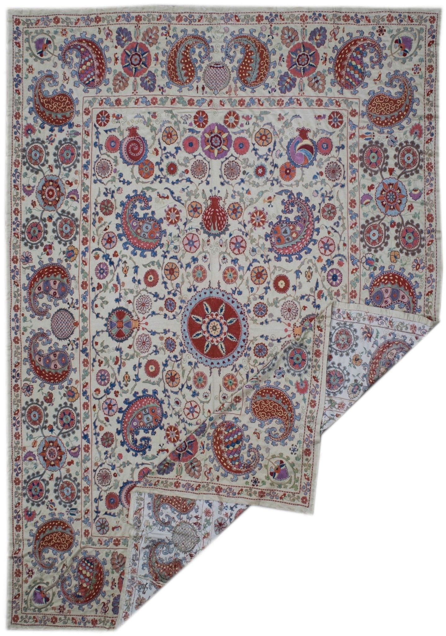 Handmade Uzbek suzani featuring intricate silk floral and paisley embroidery on a silk base.