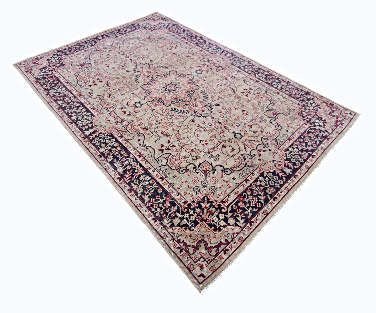 Traditional Pakistani rug featuring a central floral medallion, intricate red and navy patterns, and a detailed border.