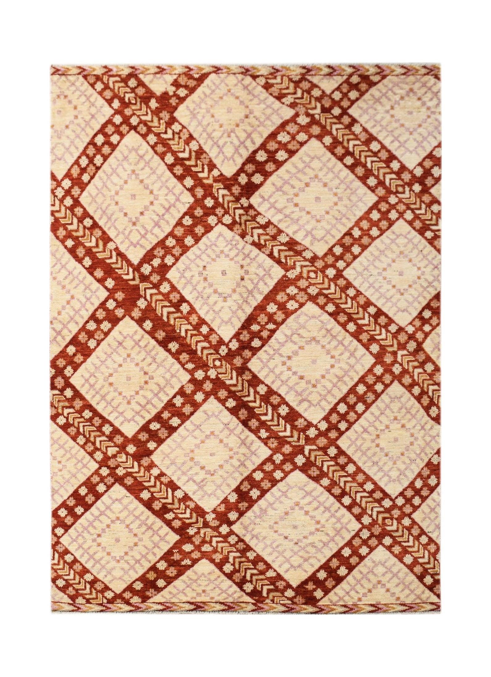 A handknotted wool rug featuring a geometric diamond pattern in rust red and cream tones.