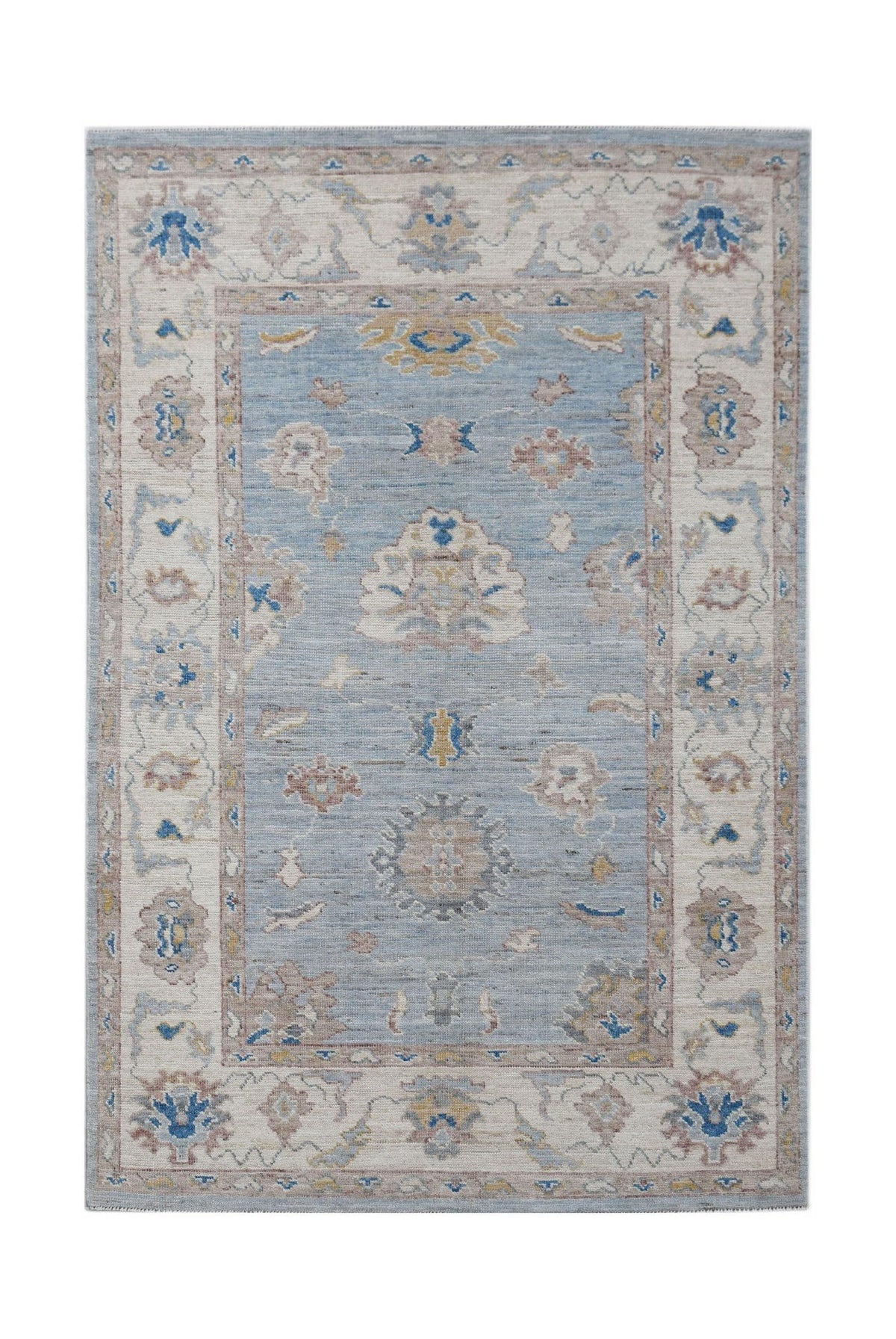 Hand-knotted Afghan Oushak rug featuring a muted blue and cream floral pattern with a soft wool texture.