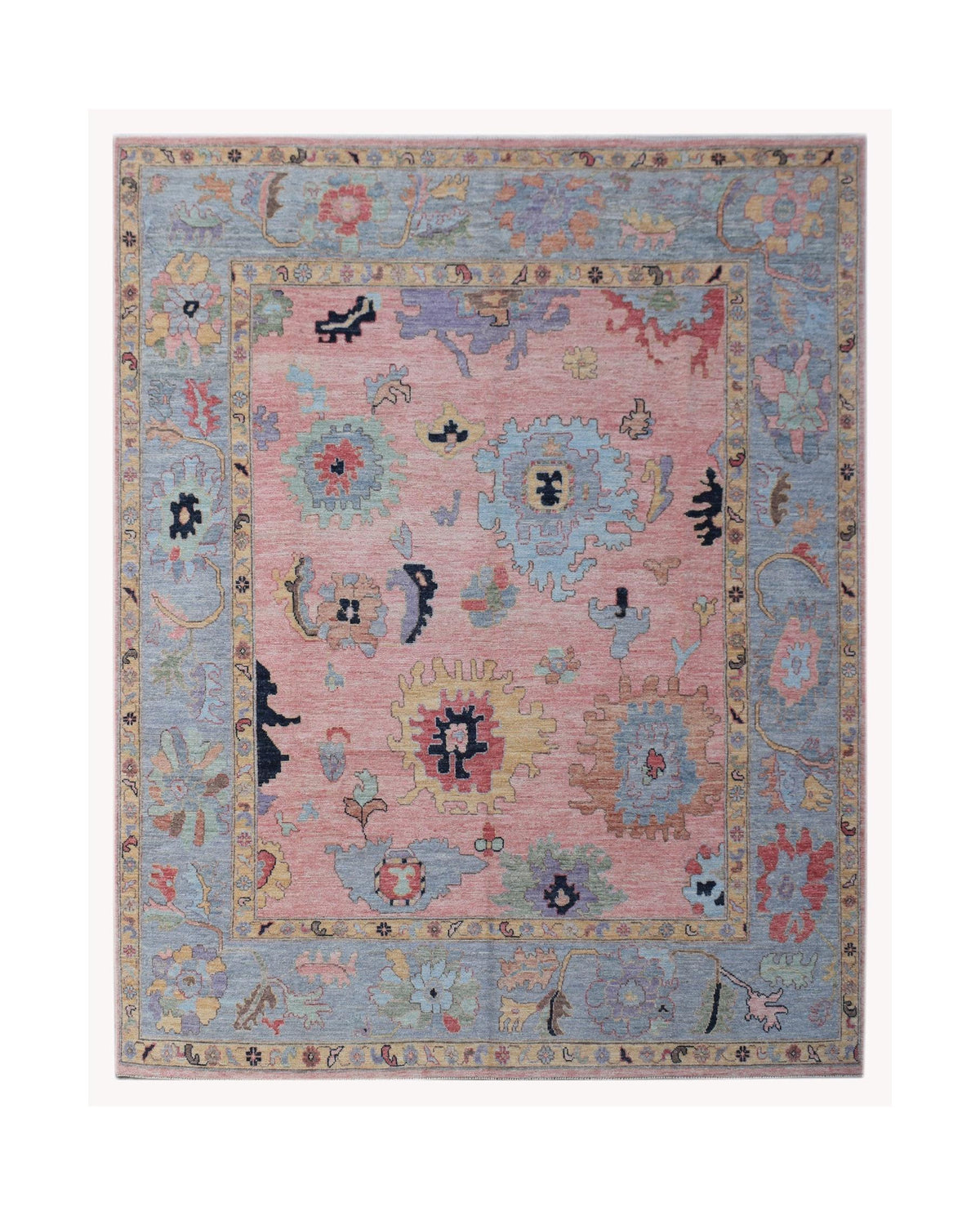 Hand-knotted Afghan Oushak rug featuring a pink central field with blue, yellow, and red floral motifs and a grey border.