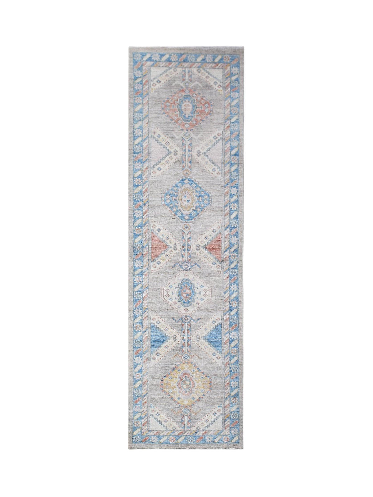 Hand-knotted transitional Oushak runner with soft blue, peach, and grey geometric medallions on a neutral field.