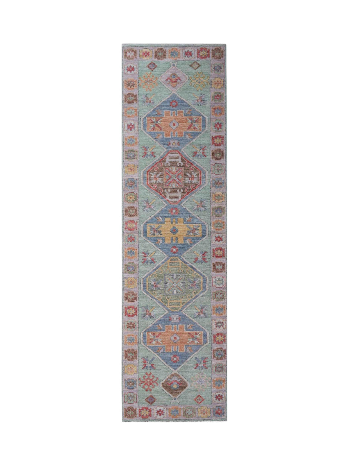 Transitional Oushak runner featuring soft medallions and palmettes in muted blue, sage green, and earthy terracotta tones.