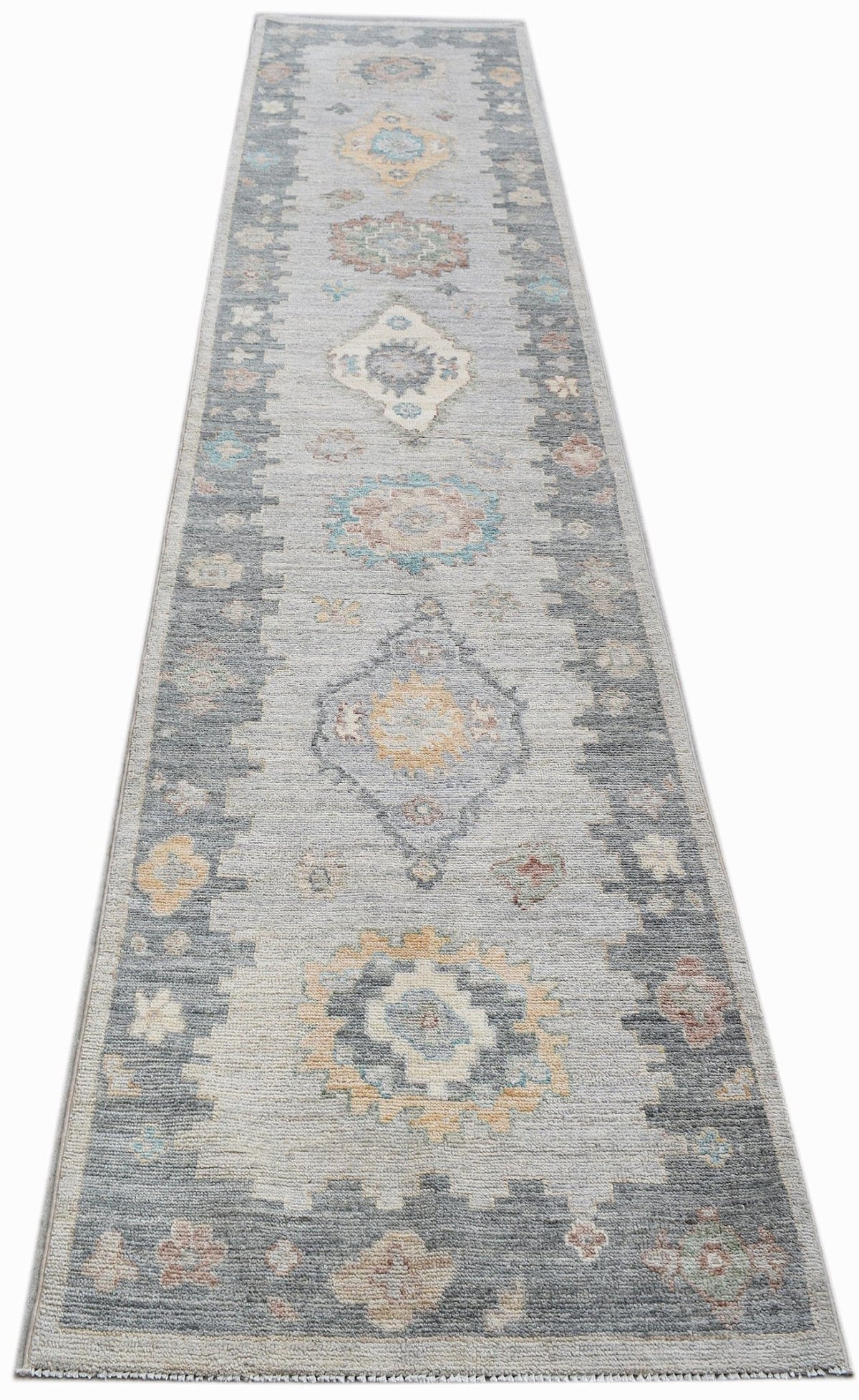 Hand-knotted transitional Oushak runner in soft grey with muted medallion and palmette patterns.