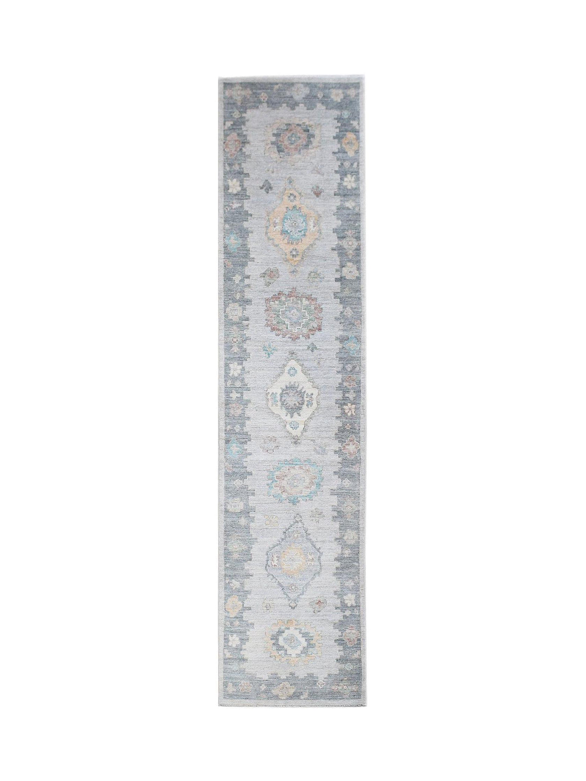 Hand-knotted transitional Oushak runner in soft grey with muted blue and peach medallion motifs.