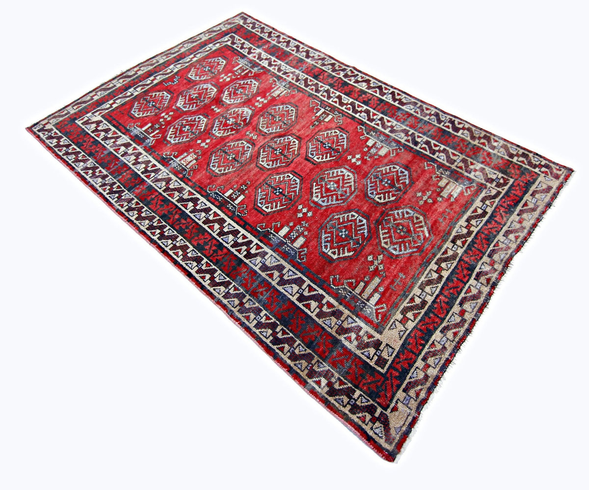 Vintage Afghan Baluch rug with a red field, geometric medallions, and intricate tribal borders in wool.