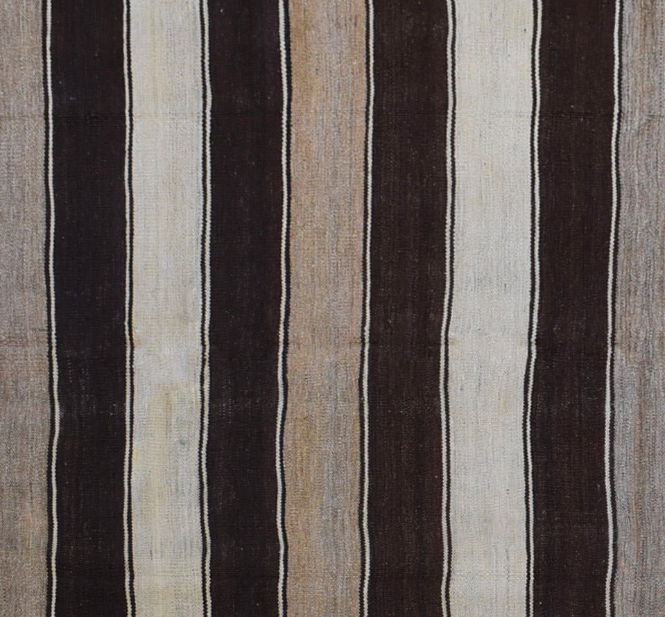 Handmade Afghan Hazara kilim rug featuring a repeating pattern of vertical brown and beige stripes.