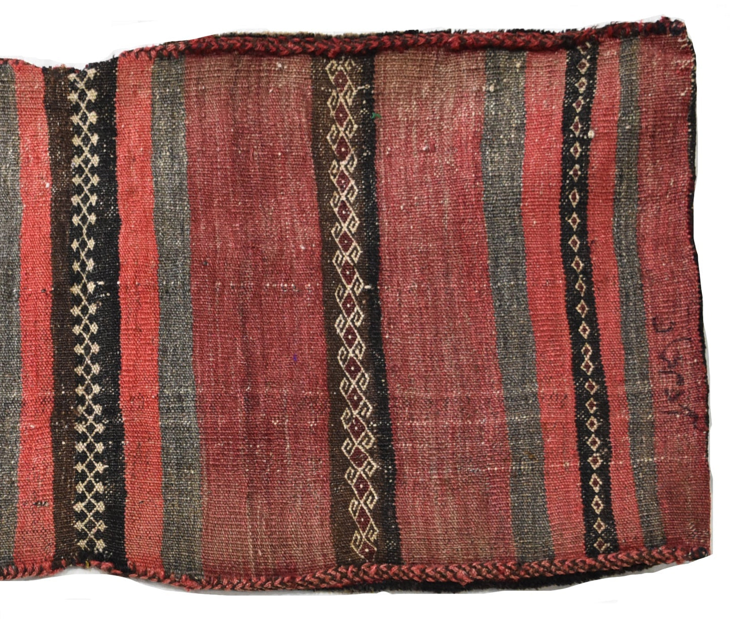 A vintage handmade Afghan wool saddle bag featuring red and grey stripes with geometric patterns.