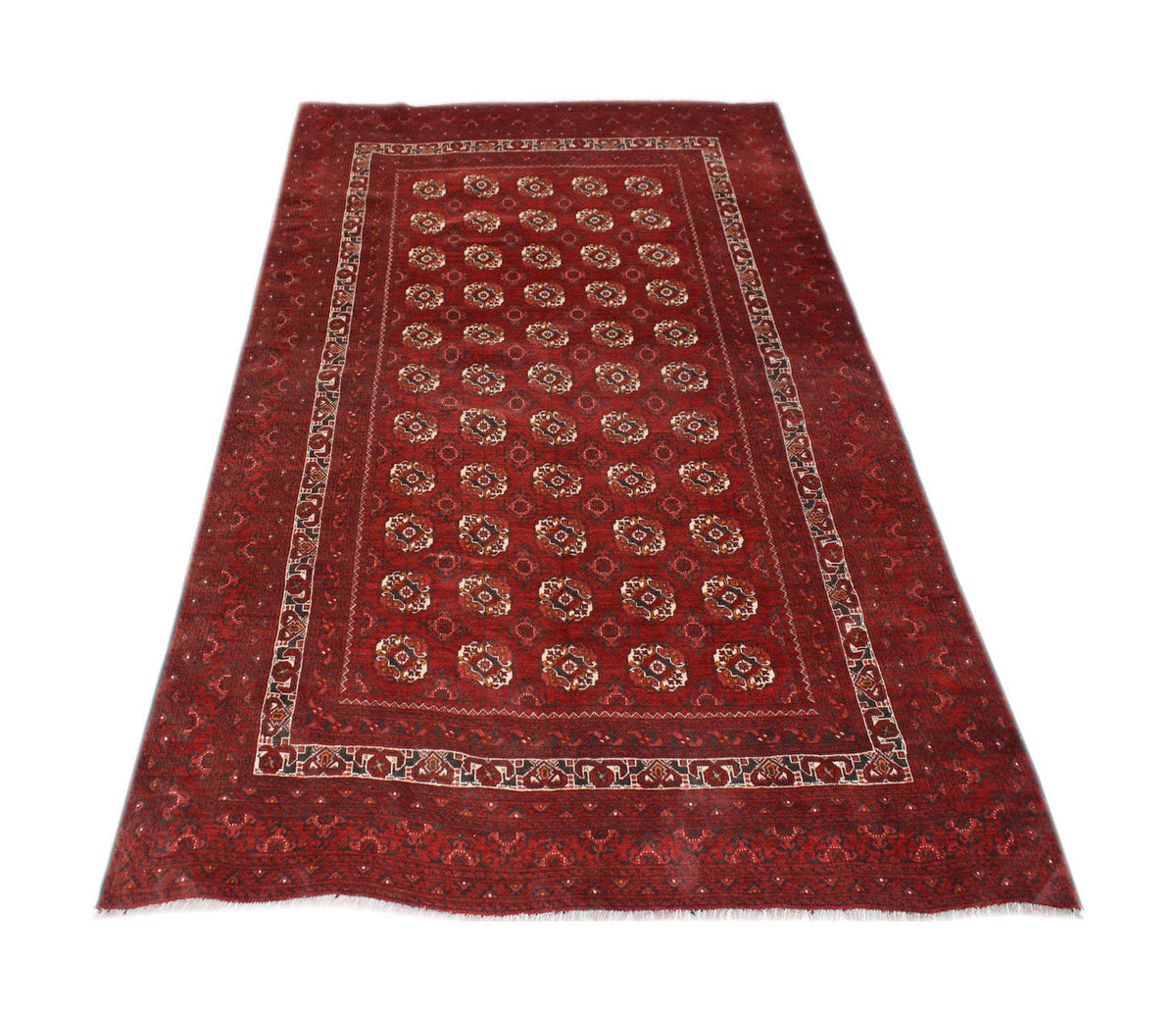 A vintage handmade Afghan Turkmen rug featuring a repeating geometric pattern on a red field.