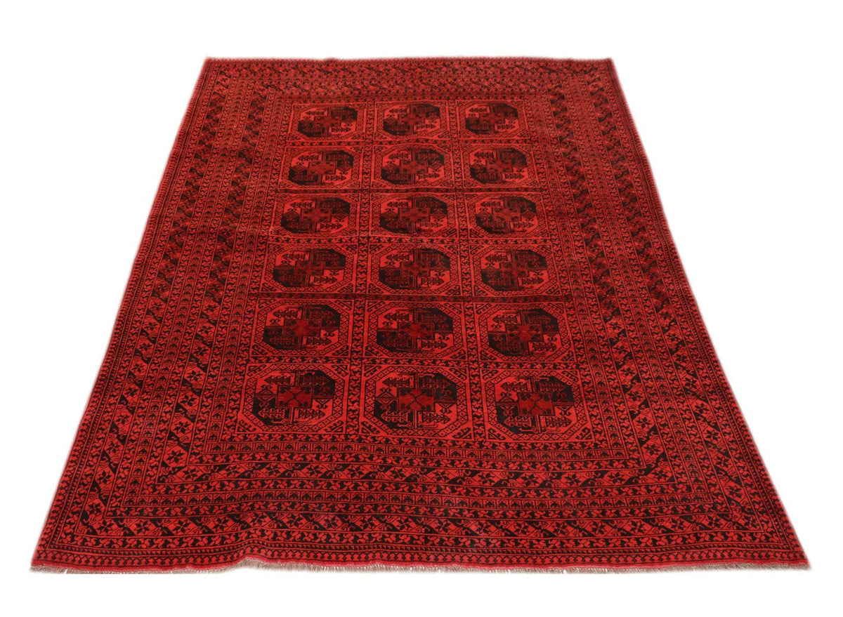 A vintage Afghan Turkmen rug featuring a repeating geometric pattern in red and black wool.