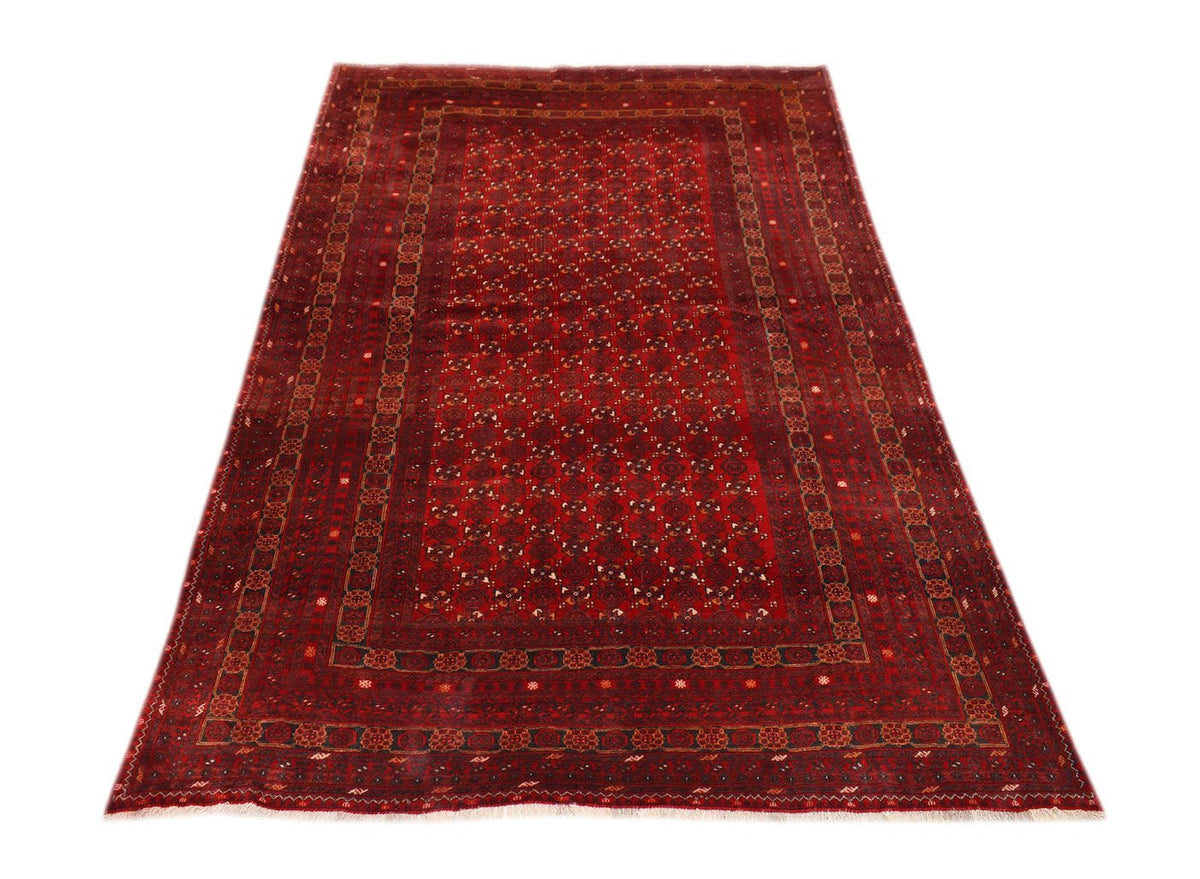 A vintage handmade Afghan Turkmen rug featuring a deep red field with repeating geometric motifs.