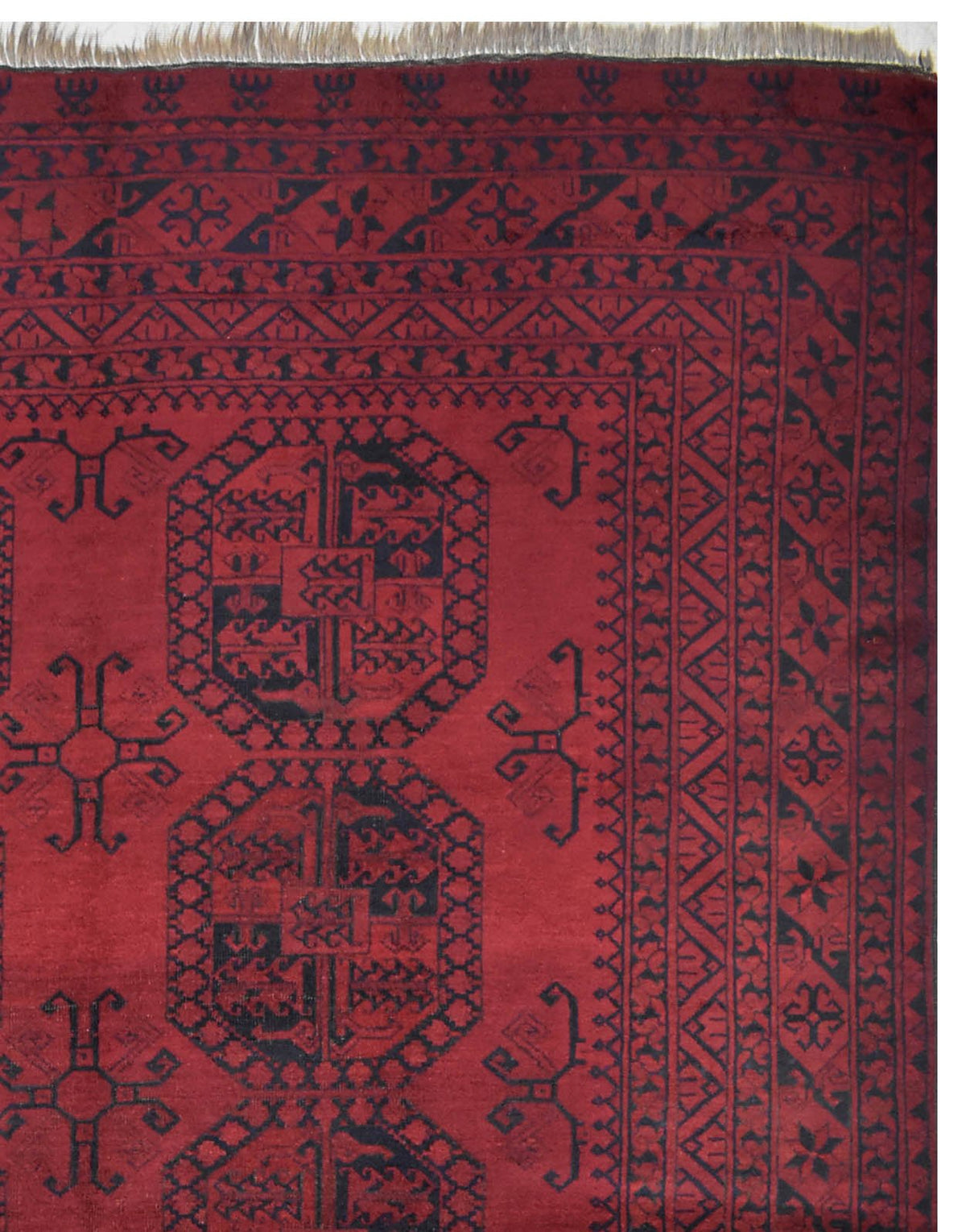 A vintage handmade Afghan Turkmen rug featuring traditional geometric octagonal motifs in red.