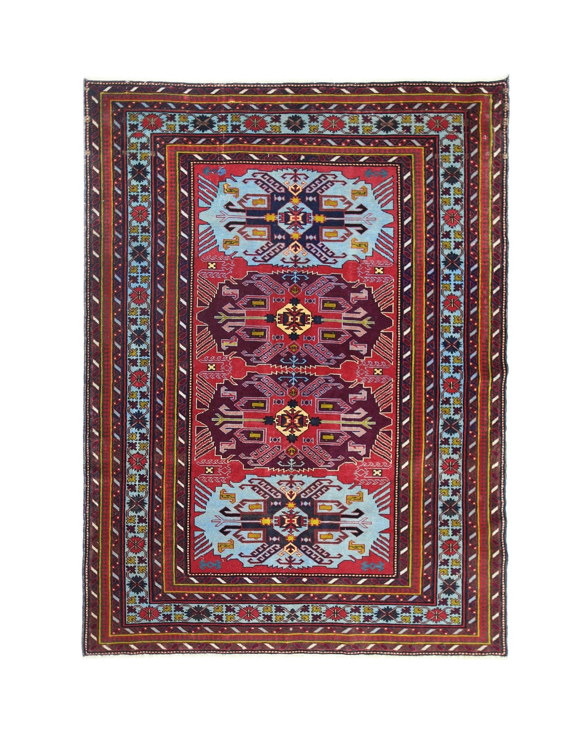 A vintage handmade Caucasian rug featuring geometric motifs in red, blue, and purple tones.