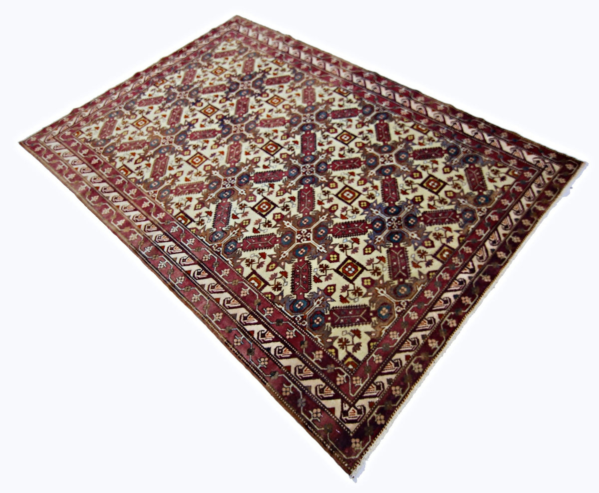 Vintage Shirvan rug with a cream field, intricate red and blue geometric medallions, and detailed floral borders.