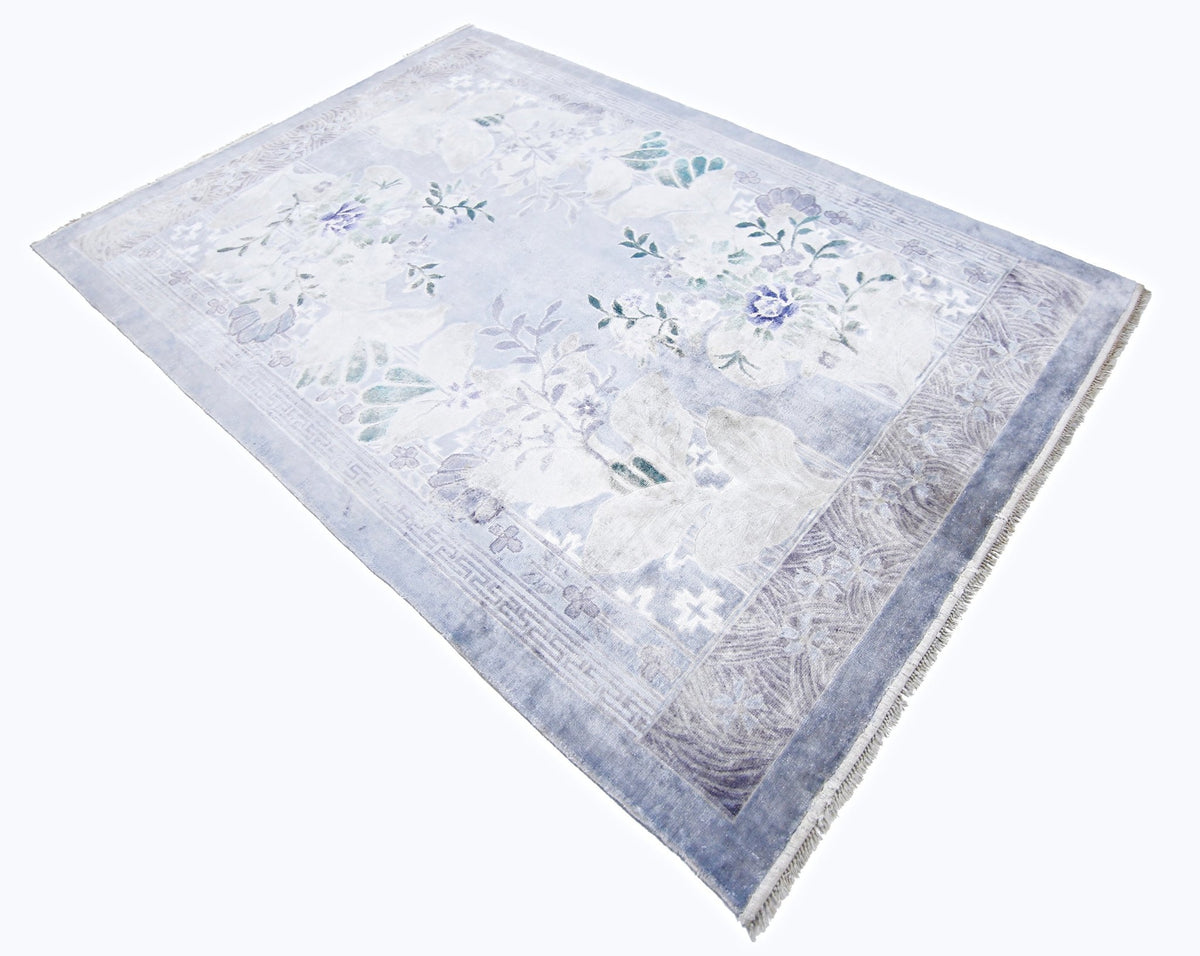 Vintage Chinese silk rug in pale blue with floral motifs, a decorative border, and a fine fringed edge.