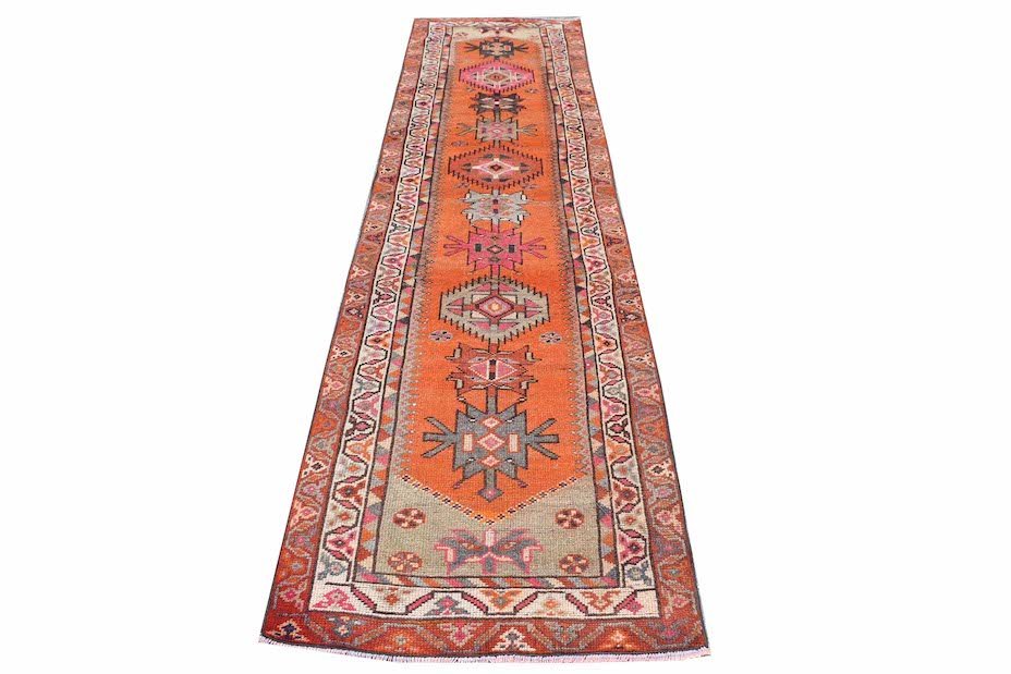 Vintage Kurdish Herki runner with orange, pink, and gray geometric patterns.