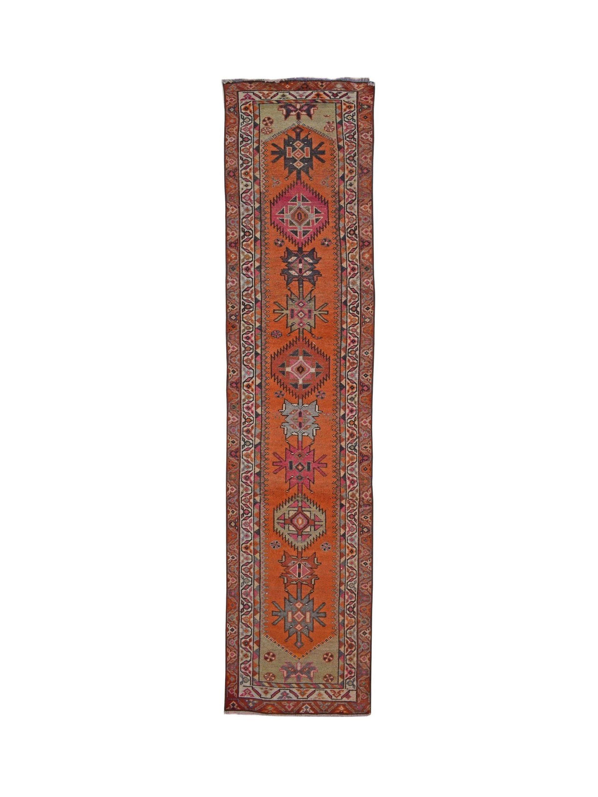 A vintage Kurdish Herki runner featuring tribal geometric motifs in vibrant orange and pink tones.