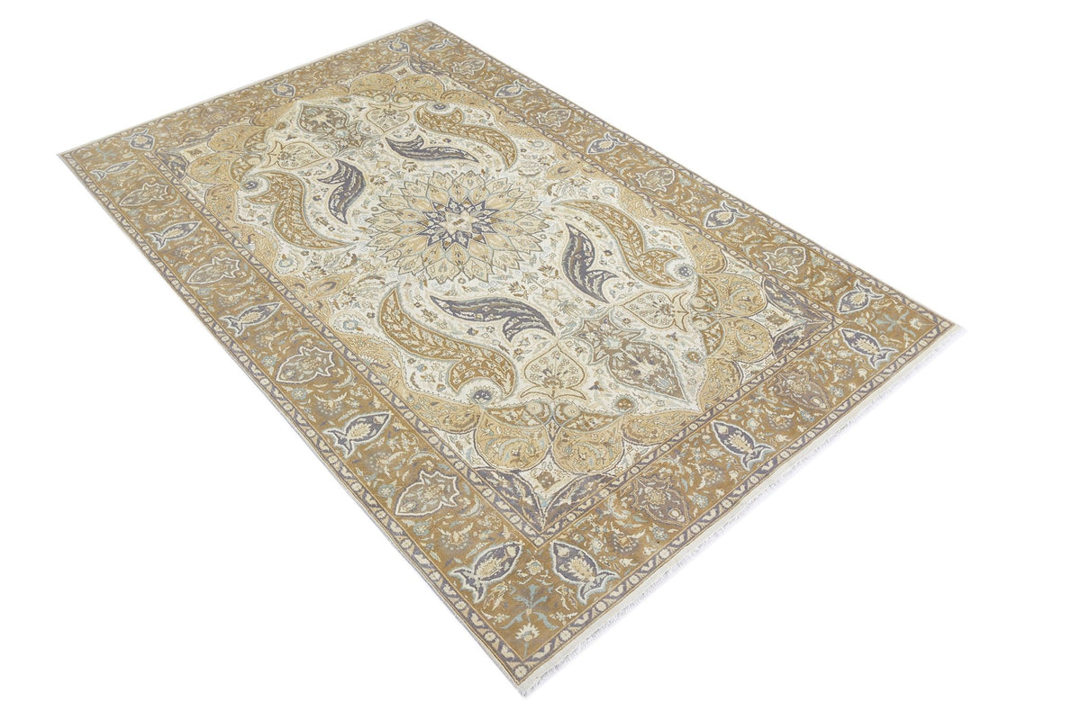 Vintage Pakistani rug featuring a central floral medallion in muted gold, cream, and grey with a detailed scrolling border.